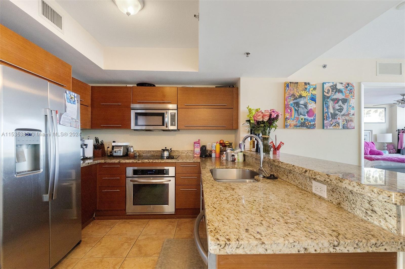 2681 North Flamingo Road, Unit 1405S Sunrise, FL 33323 - Photo 2 of 28 a kitchen with stainless steel appliances granite countertop a stove a sink and a refrigerator