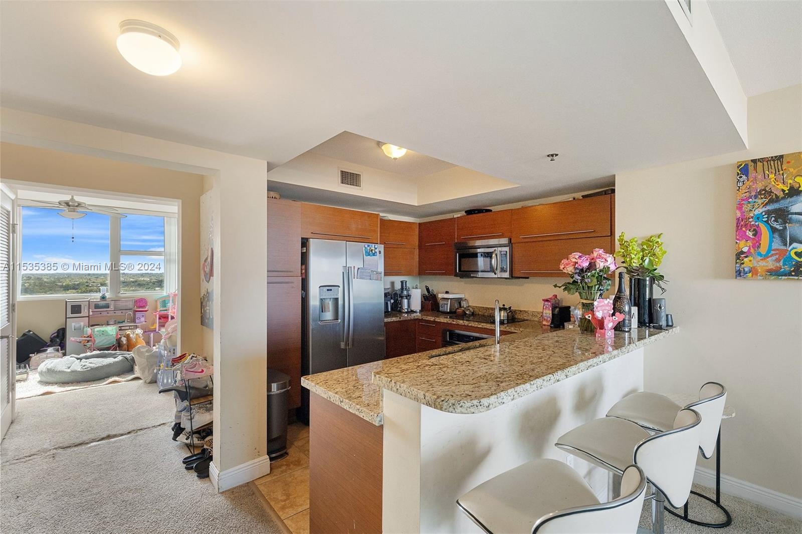 2681 North Flamingo Road, Unit 1405S Sunrise, FL 33323 - Photo 3 of 28 a kitchen with sink refrigerator and microwave