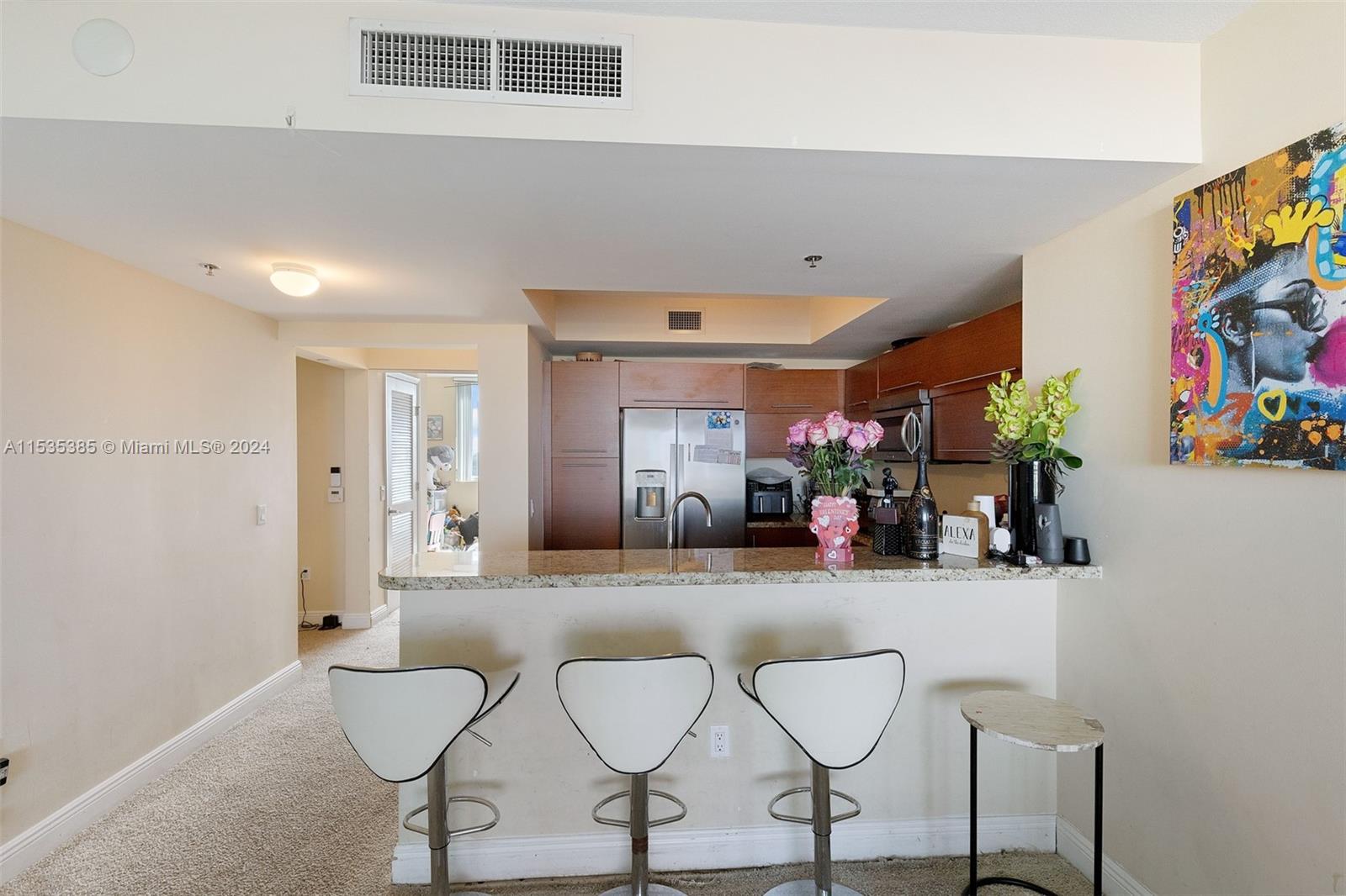 2681 North Flamingo Road, Unit 1405S Sunrise, FL 33323 - Photo 4 of 28 a dining room with furniture and a flat screen tv