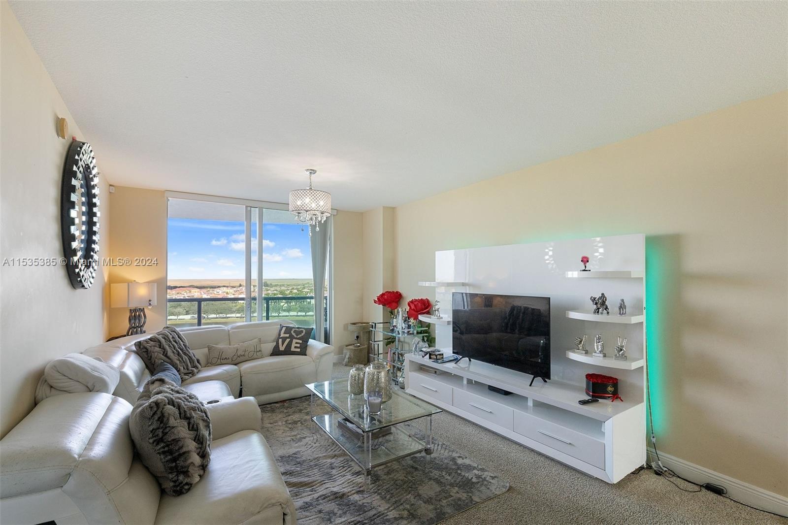 2681 North Flamingo Road, Unit 1405S Sunrise, FL 33323 - Photo 5 of 28 a living room with furniture and a flat screen tv