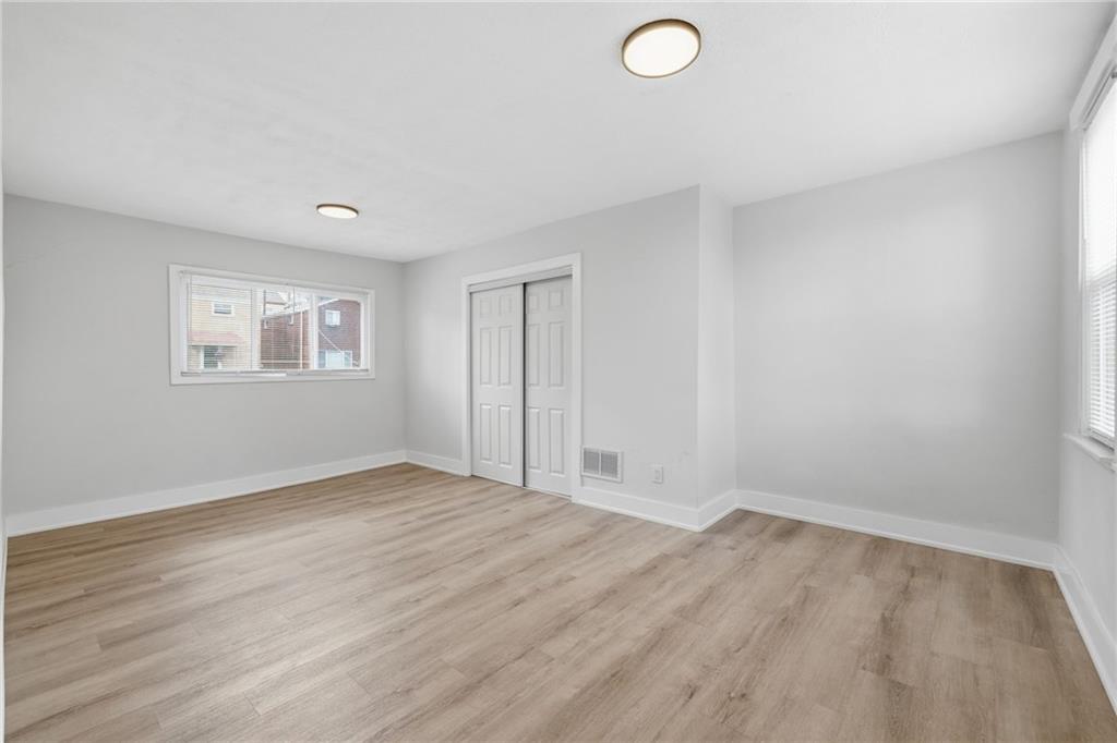 2961 Ruthwood Avenue Pittsburgh, PA 15227 - Photo 18 of 29 an empty room with wooden floor and windows