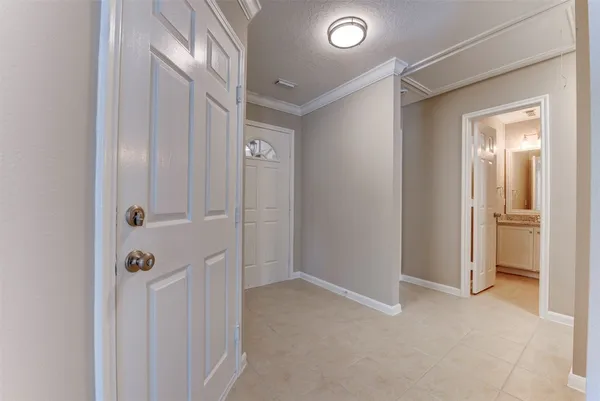 a view of an empty room with wooden floor fireplace and a window