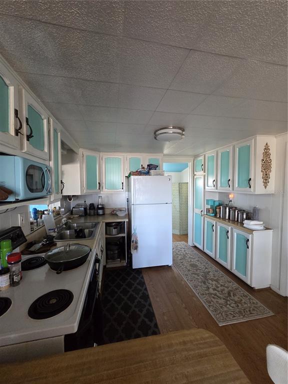 1024 Strickland Road Okeechobee, FL 34974 - Photo 13 of 23 a kitchen with refrigerator and stove