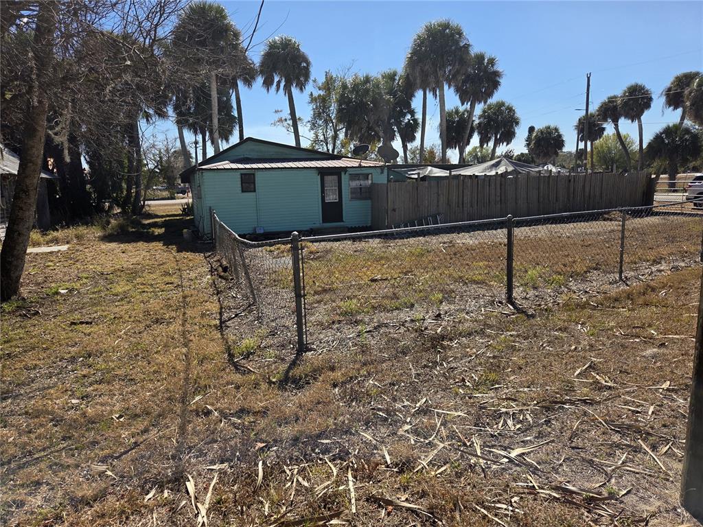 1024 Strickland Road Okeechobee, FL 34974 - Photo 22 of 23 a view of a yard with plants and brick wall