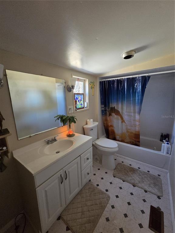 1024 Strickland Road Okeechobee, FL 34974 - Photo 10 of 23 a bathroom with a sink toilet and shower