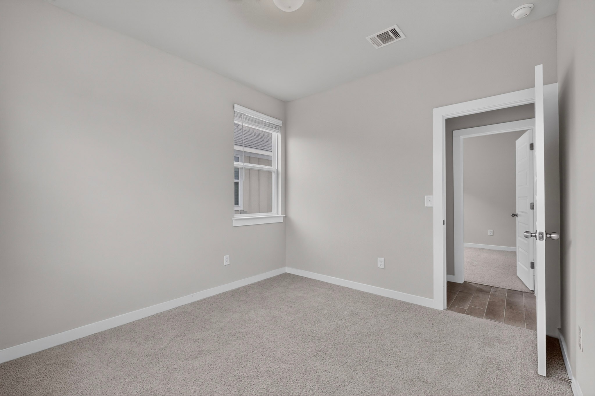 116 Appleberry Lane Elgin, TX 78621 - Photo 27 of 35 An inviting room with plush carpeting and a large window awaits your personal touch.