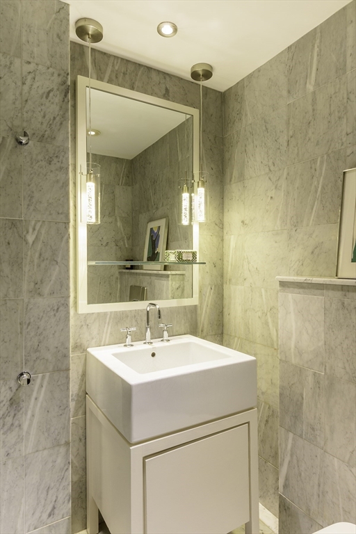 15 Charter Street, Unit 4 Boston, MA 02113 - Photo 18 of 42 a bathroom with a sink mirror and vanity