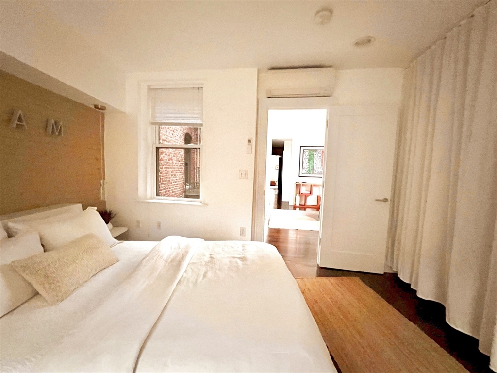 15 Charter Street, Unit 4 Boston, MA 02113 - Photo 26 of 42 a bedroom with a bed and a mirror