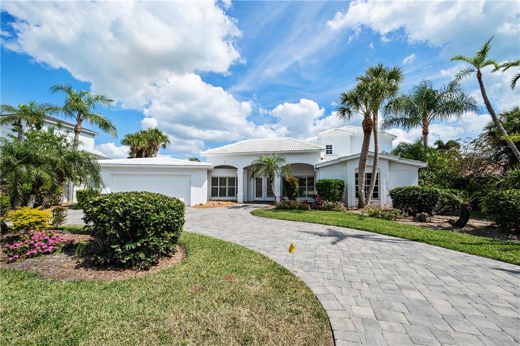 560 Outrigger Lane Longboat Key, FL 34228 - Photo 1 of 1 a front view of a house with a yard and potted plants