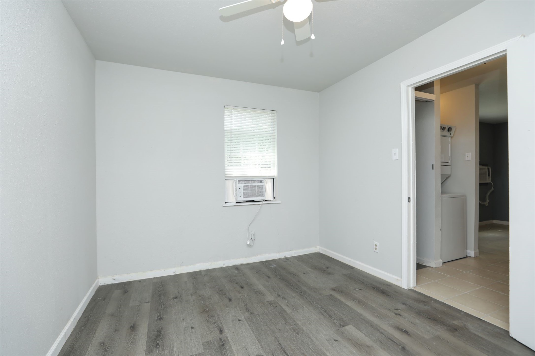 2814 Winbern Street Houston, TX 77004 - Photo 12 of 21 an empty room with wooden floor and windows