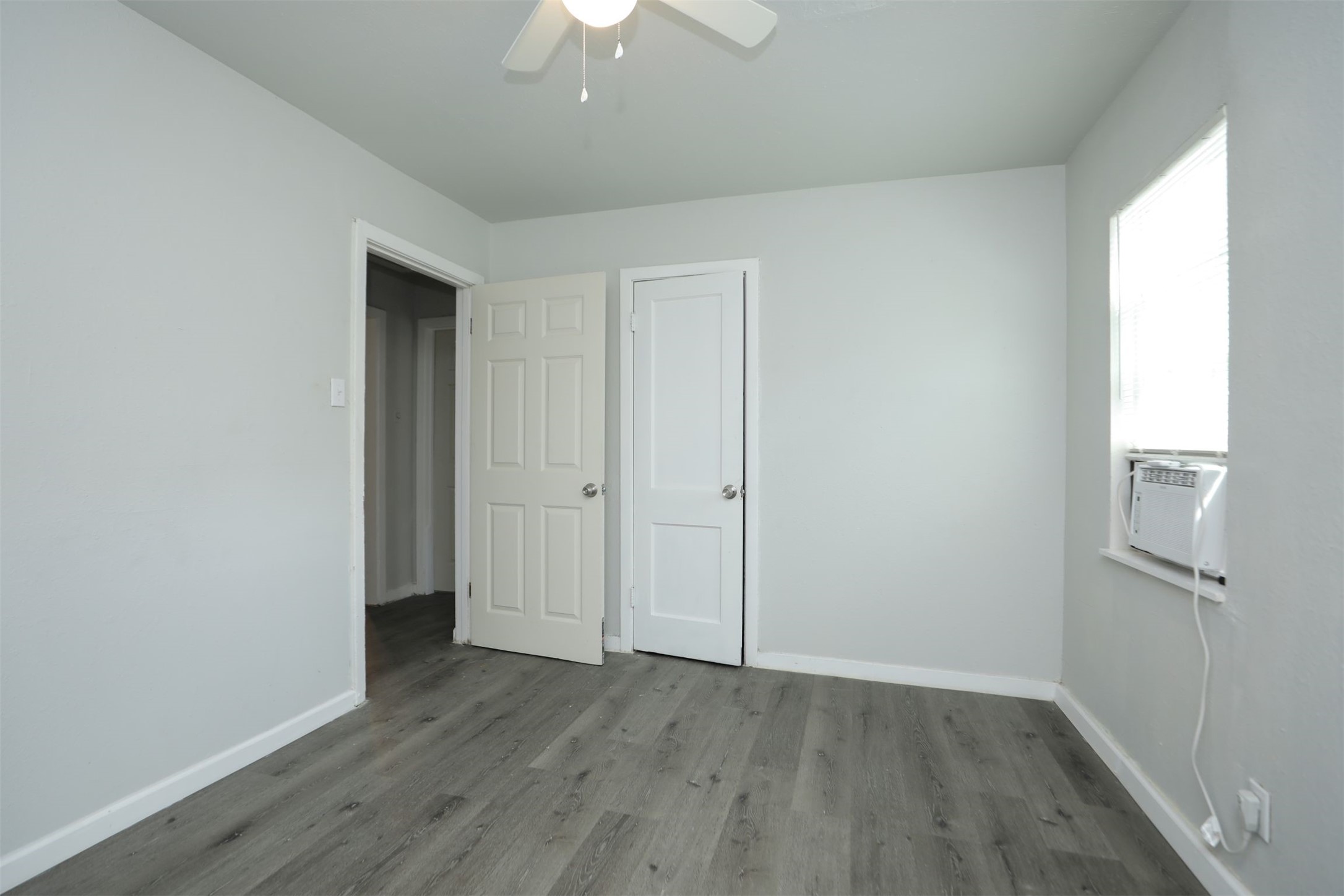 2814 Winbern Street Houston, TX 77004 - Photo 18 of 21 an empty room with wooden floor and a ceiling fan