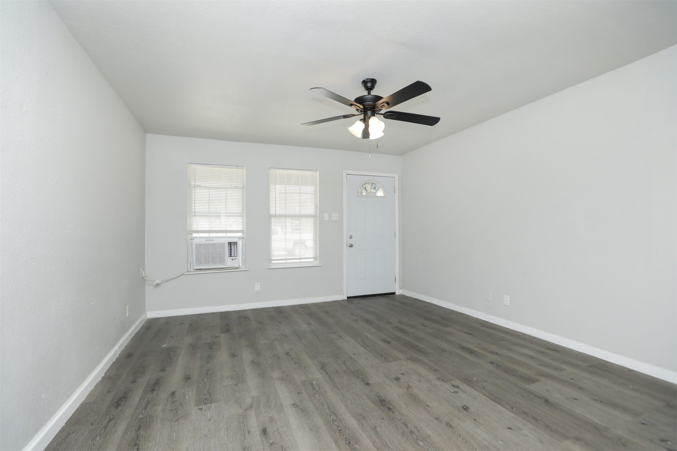 2814 Winbern Street Houston, TX 77004 - Photo 3 of 21 a view of empty room with wooden floor and fan