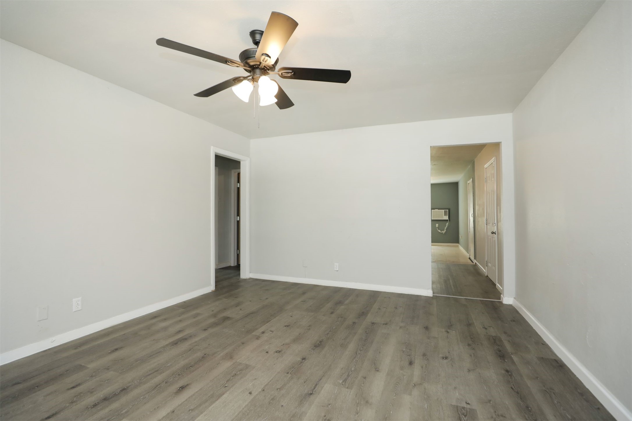 2814 Winbern Street Houston, TX 77004 - Photo 5 of 21 a view of an empty room with wooden floor