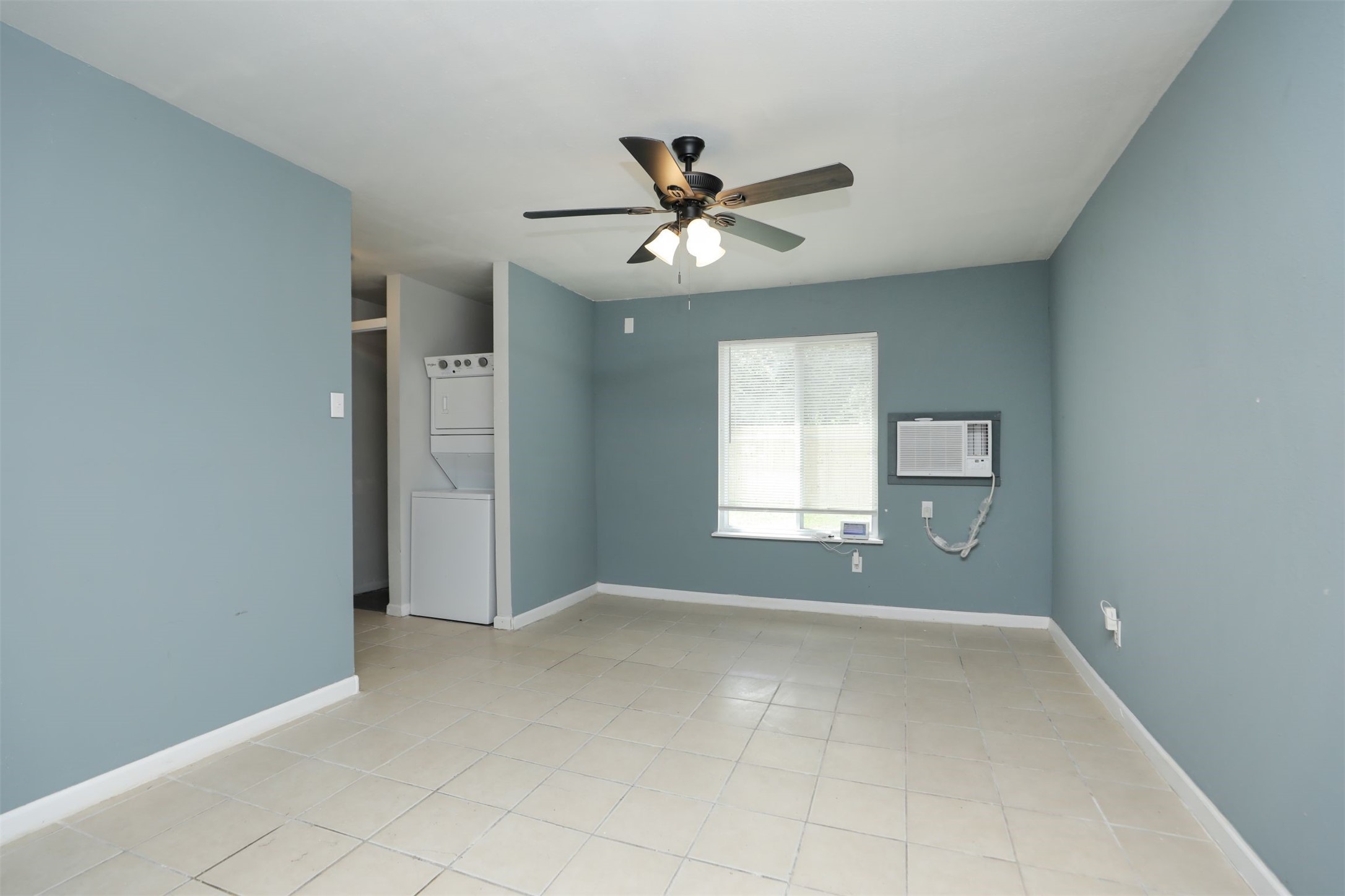 2814 Winbern Street Houston, TX 77004 - Photo 9 of 21 an empty room with windows and fan