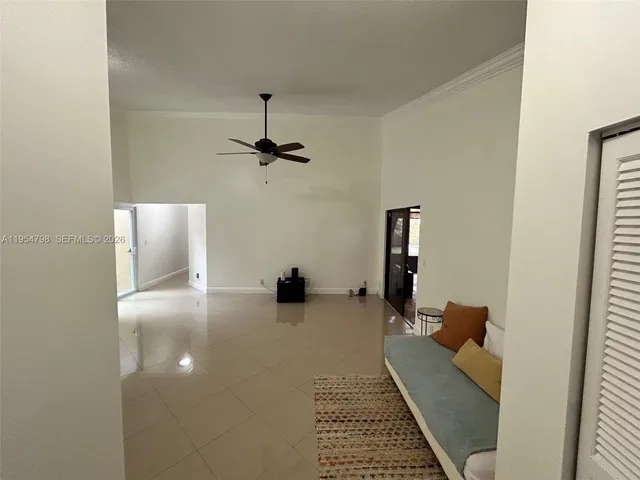 a living room with furniture and a air conditioner vent