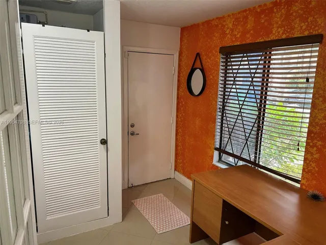 a kitchen with granite countertop a stove sink and microwave