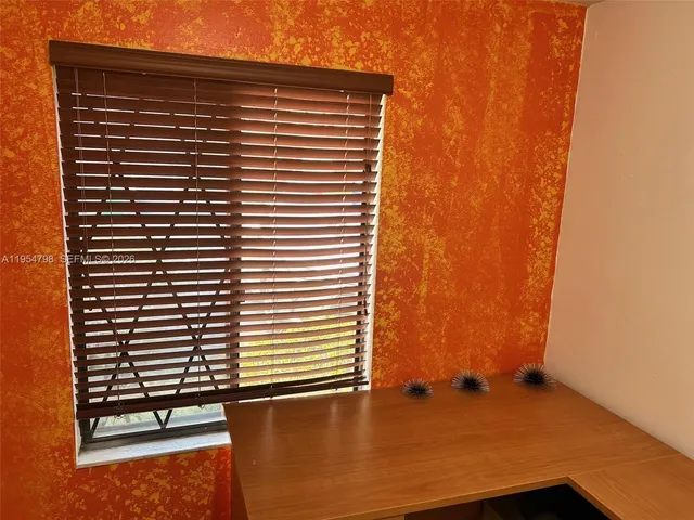 a view of a hallway with wooden floor and entryway