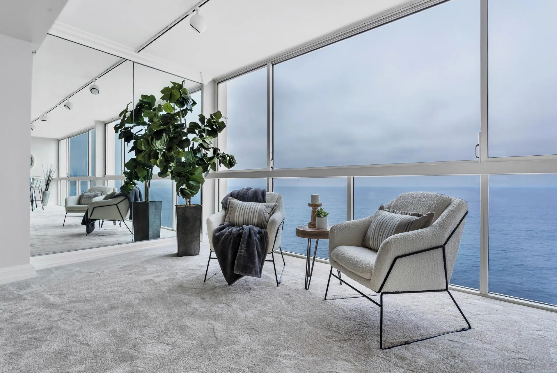 939 Coast Boulevard, Unit 12C La Jolla, CA 92037 - Photo 13 of 41 a living room with furniture and a potted plant
