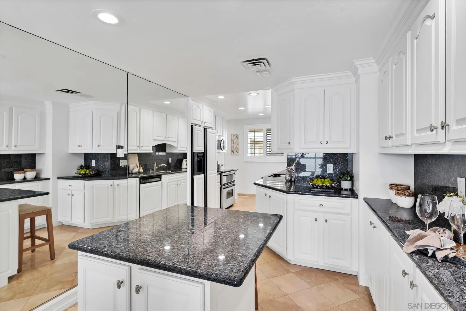 939 Coast Boulevard, Unit 12C La Jolla, CA 92037 - Photo 14 of 41 a kitchen with stainless steel appliances granite countertop a sink a stove and cabinets