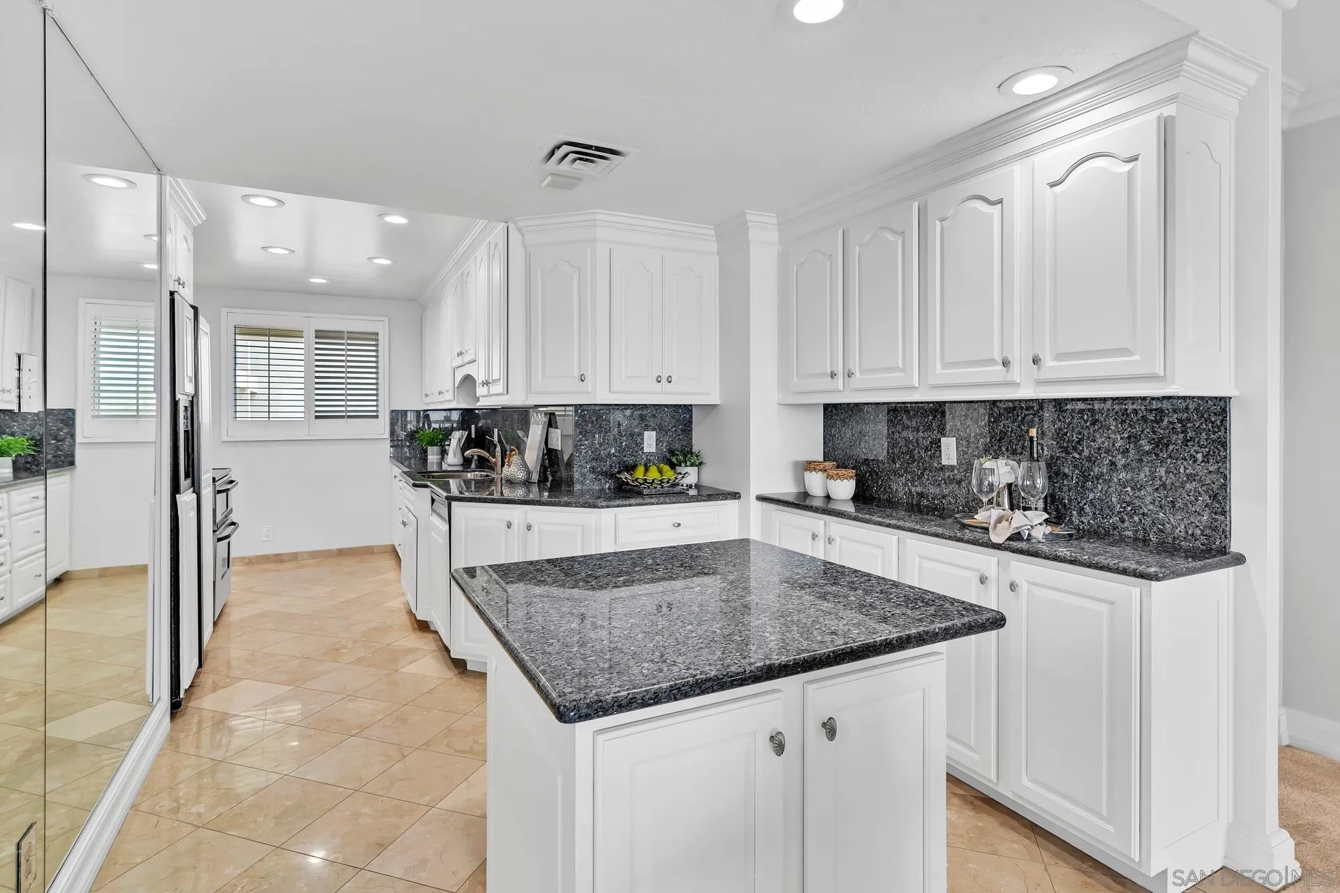 939 Coast Boulevard, Unit 12C La Jolla, CA 92037 - Photo 15 of 41 a kitchen with stainless steel appliances granite countertop a stove a sink and a refrigerator