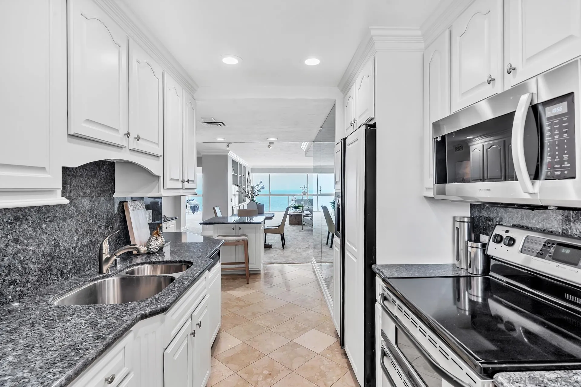 939 Coast Boulevard, Unit 12C La Jolla, CA 92037 - Photo 17 of 41 a kitchen with stainless steel appliances granite countertop a sink stove and refrigerator