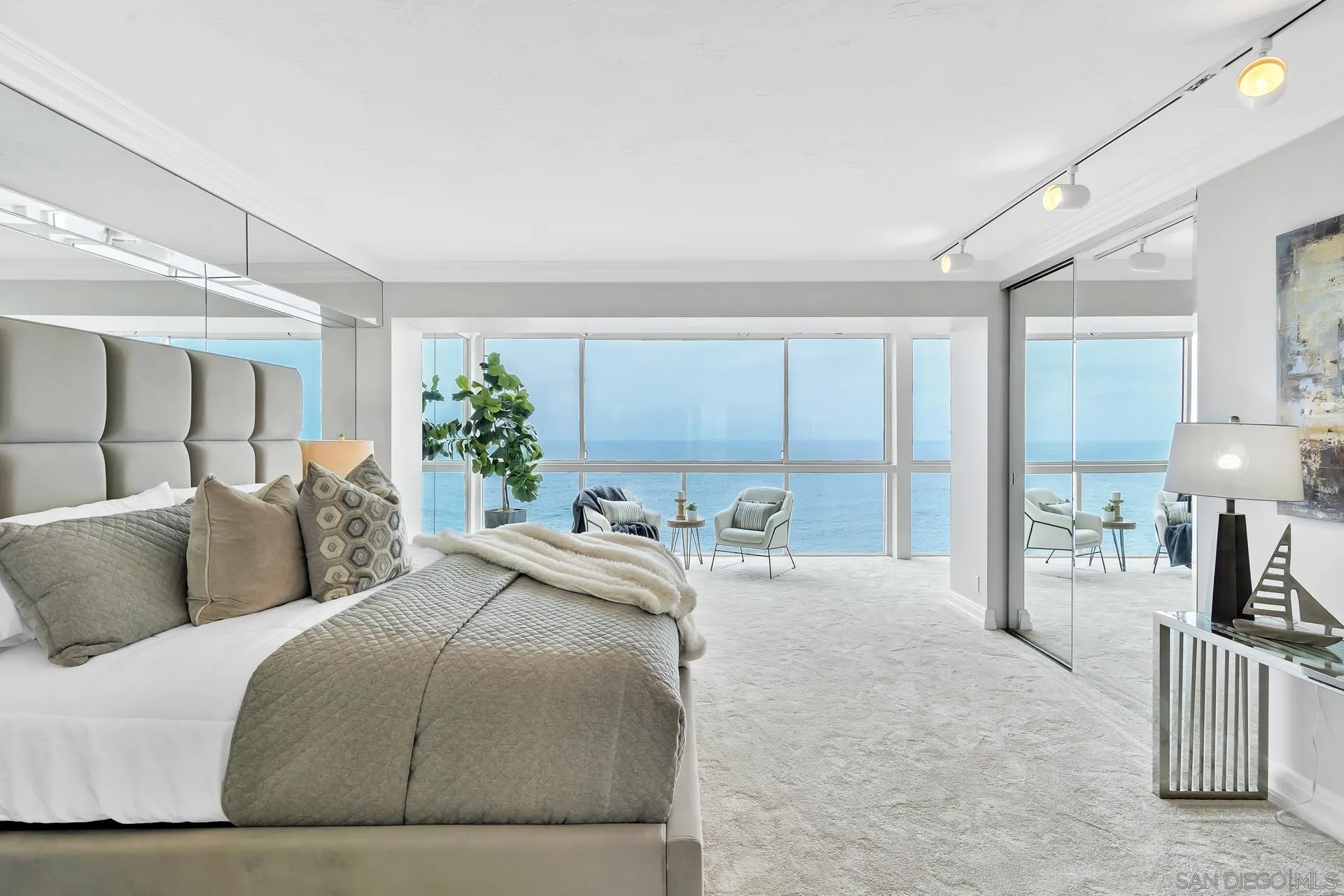 939 Coast Boulevard, Unit 12C La Jolla, CA 92037 - Photo 22 of 41 a bedroom with a large bed and a chandelier