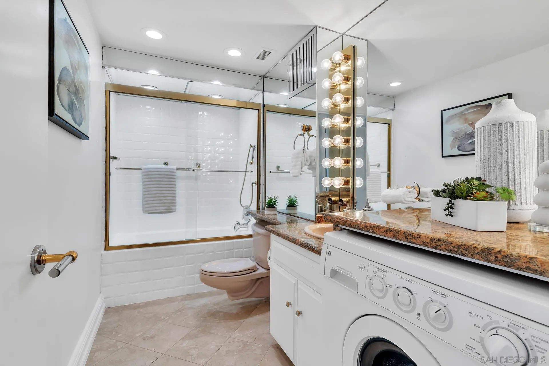 939 Coast Boulevard, Unit 12C La Jolla, CA 92037 - Photo 27 of 41 a bathroom with a granite countertop sink mirror vanity and toilet