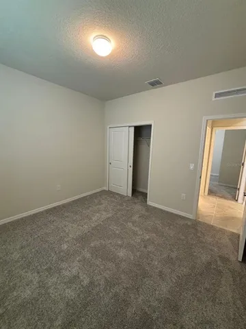 an empty room with a empty space and windows