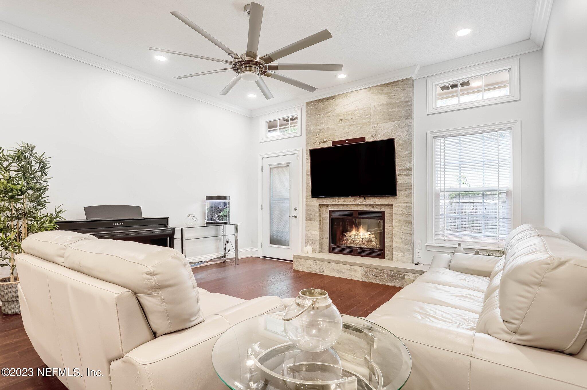 613 Hummingbird Court St. Johns, FL 32259 - Photo 11 of 29 a living room with furniture a fireplace and a flat screen tv