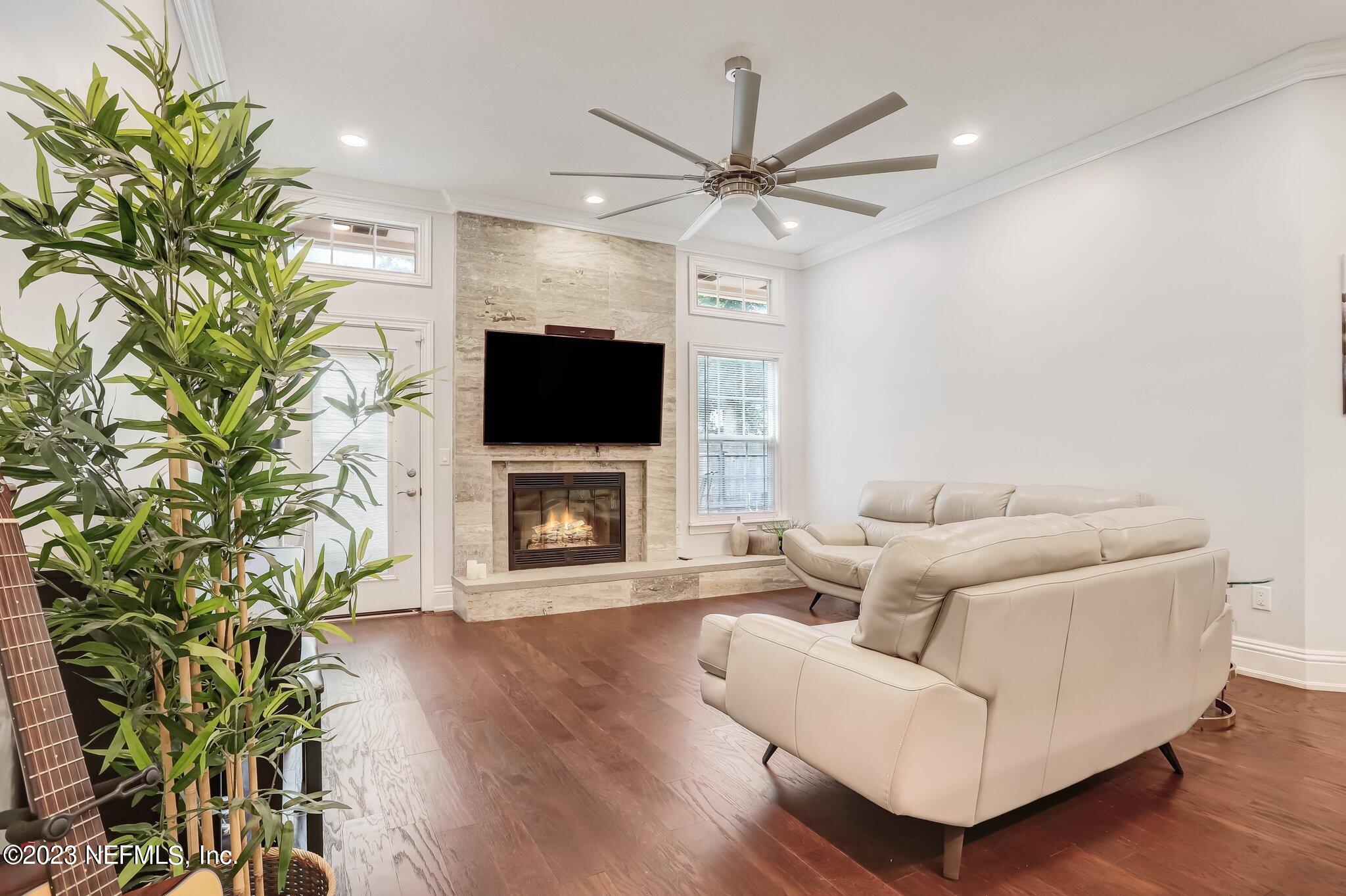 613 Hummingbird Court St. Johns, FL 32259 - Photo 12 of 29 a living room with furniture a fireplace and a flat screen tv