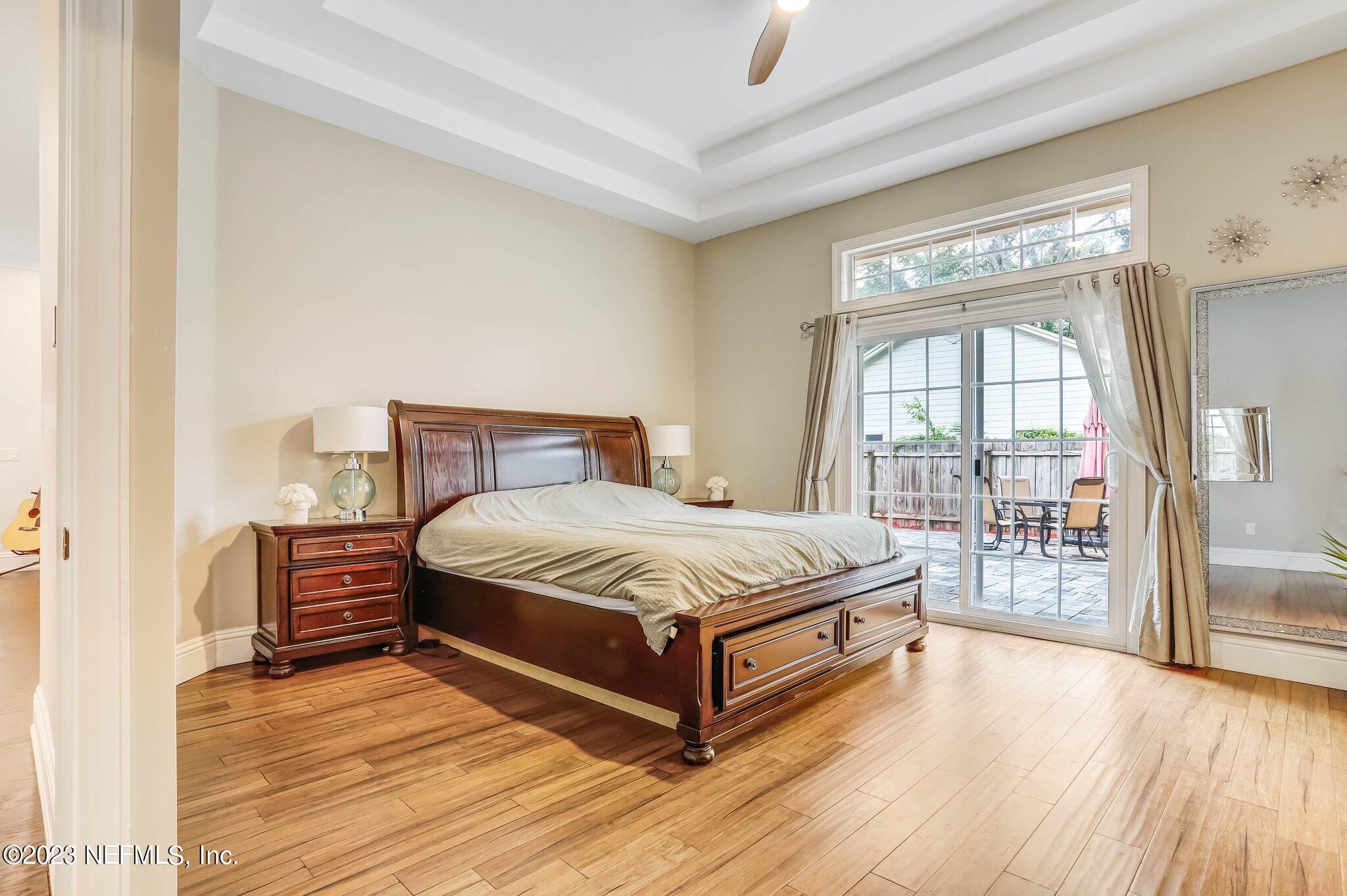 613 Hummingbird Court St. Johns, FL 32259 - Photo 14 of 29 a bedroom with a large bed and wooden floor