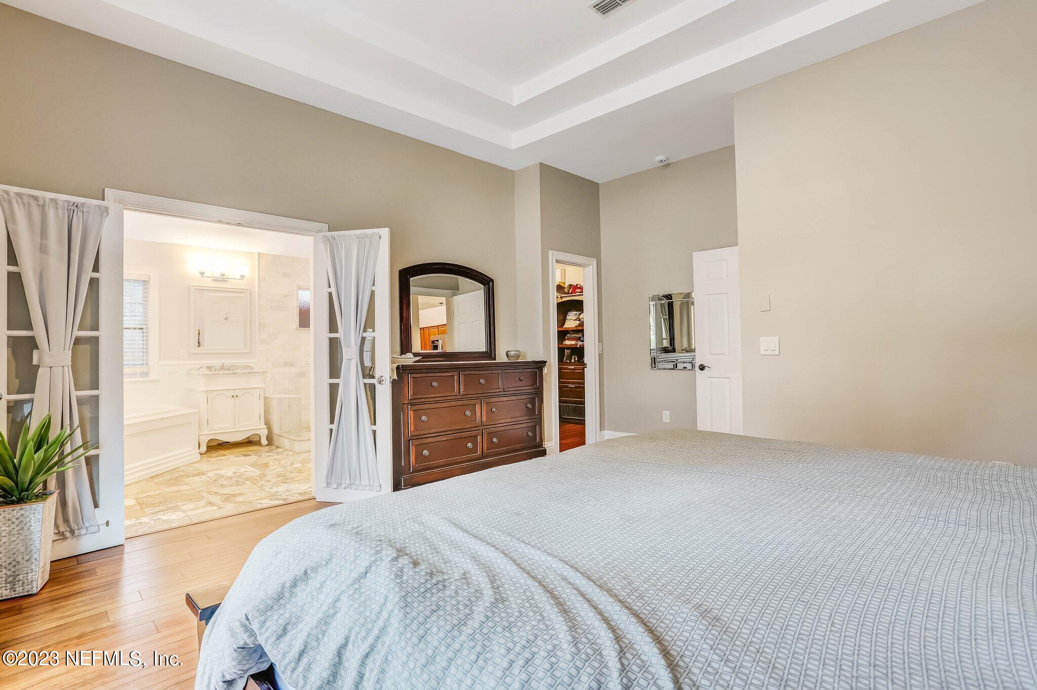 613 Hummingbird Court St. Johns, FL 32259 - Photo 15 of 29 a bedroom with a bed and a large mirror on the dresser