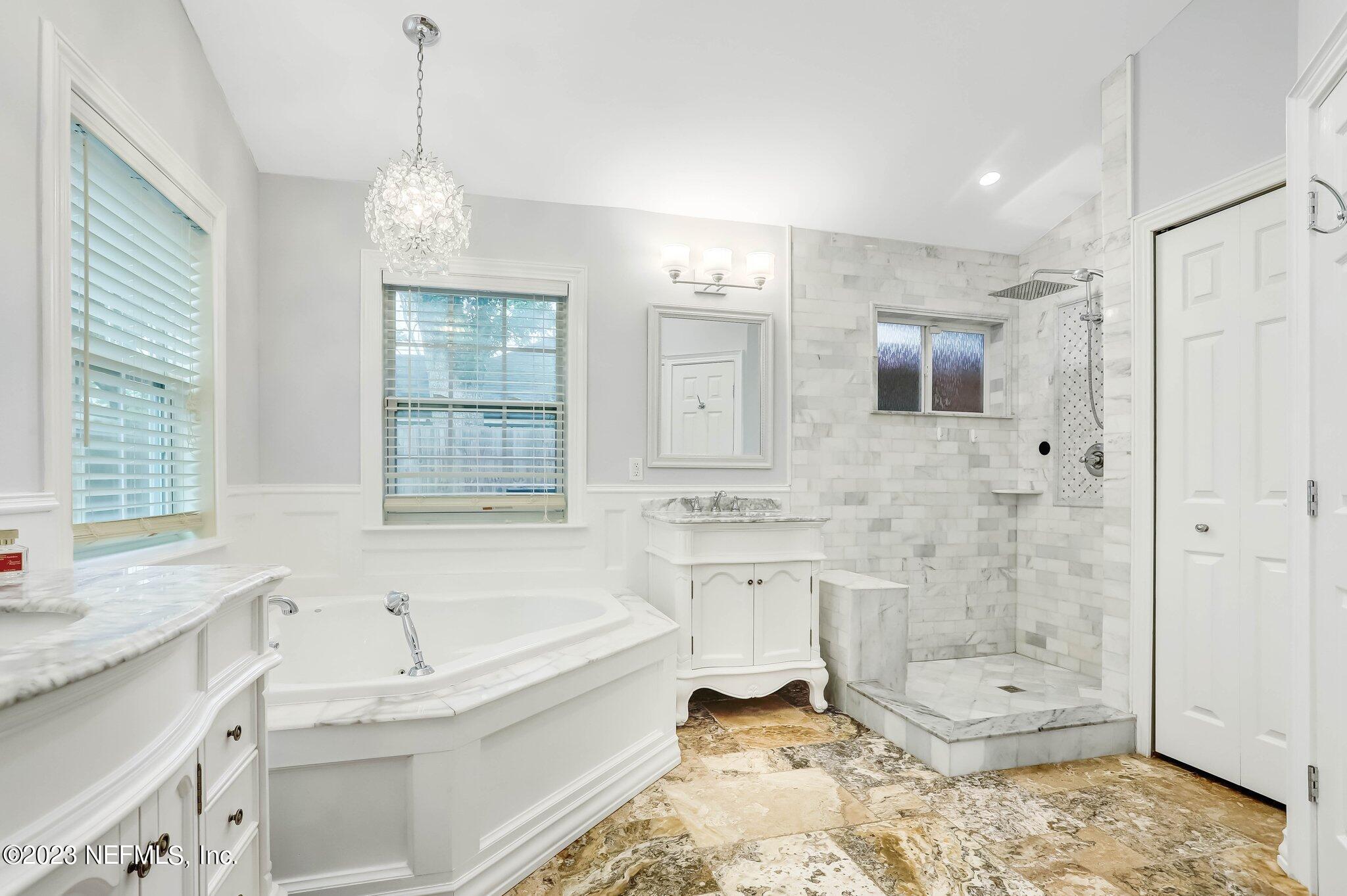 613 Hummingbird Court St. Johns, FL 32259 - Photo 16 of 29 a bathroom with a bathtub shower sink and mirror