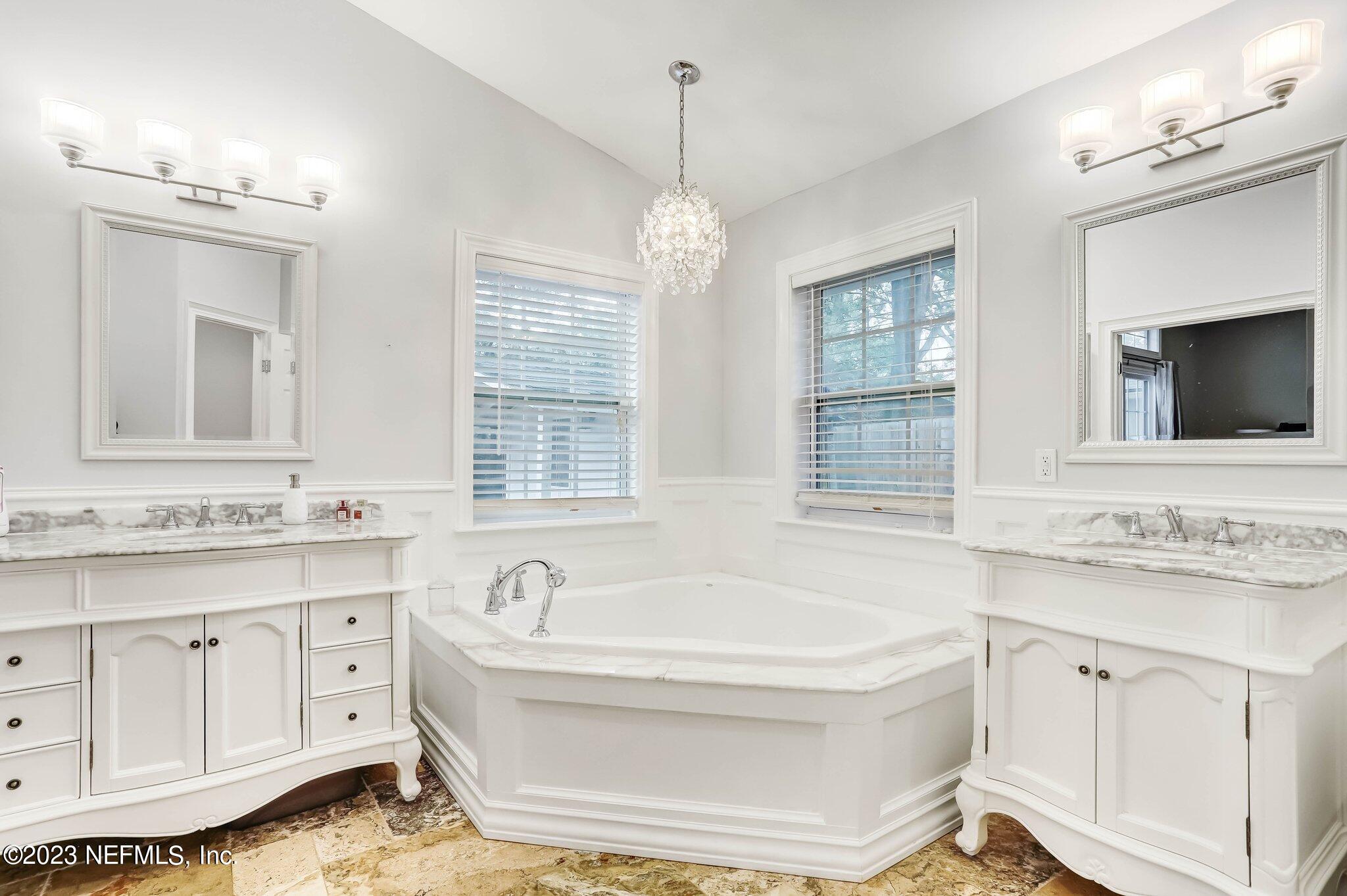 613 Hummingbird Court St. Johns, FL 32259 - Photo 17 of 29 a bathroom with a tub sink and mirror