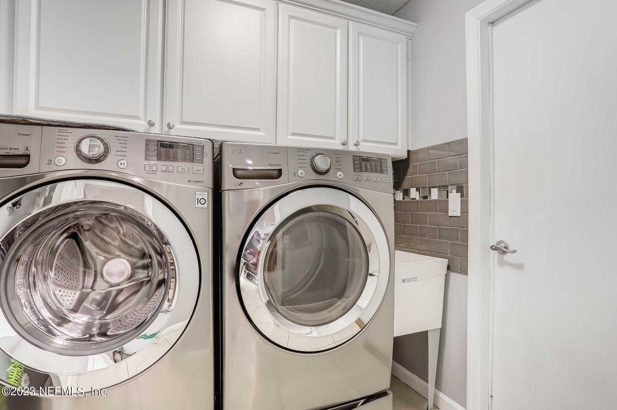 613 Hummingbird Court St. Johns, FL 32259 - Photo 23 of 29 a utility room with dryer and washer