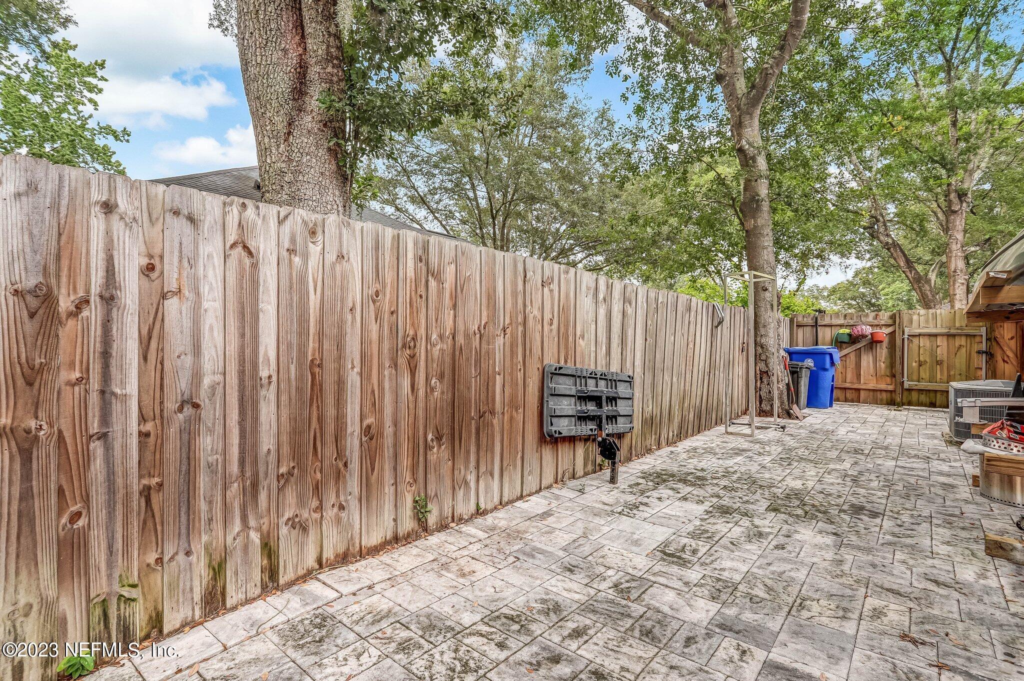 613 Hummingbird Court St. Johns, FL 32259 - Photo 27 of 29 a row of wooden fence with a trees in the background