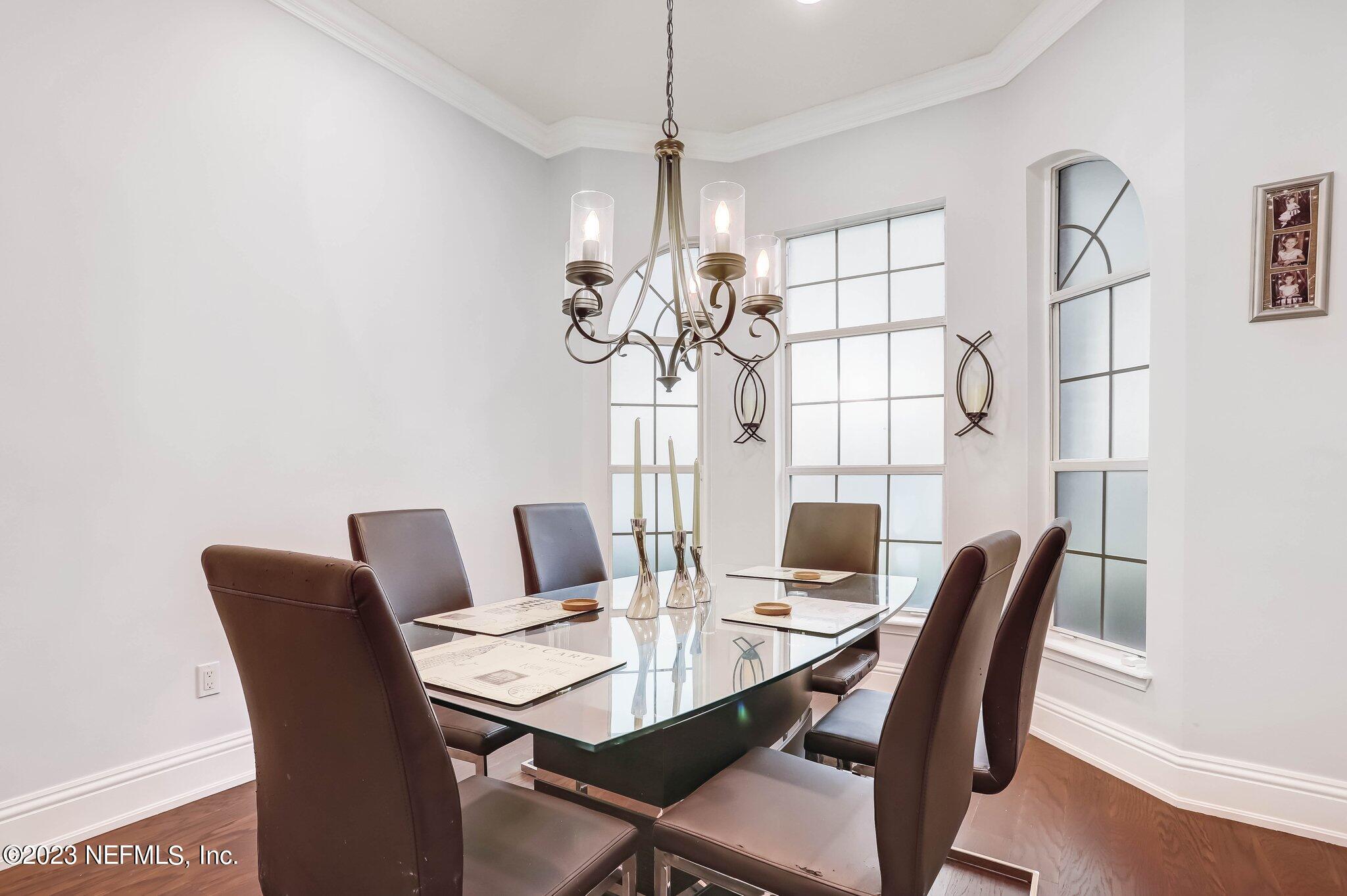 613 Hummingbird Court St. Johns, FL 32259 - Photo 7 of 29 a view of a dining room with furniture a chandelier and wooden floor