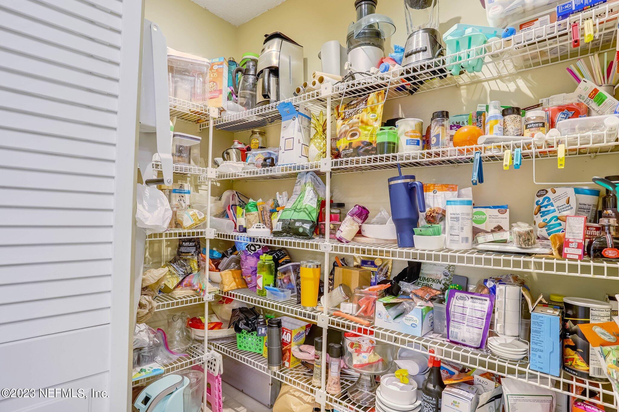 613 Hummingbird Court St. Johns, FL 32259 - Photo 10 of 29 a store room with lots of different colored cloths