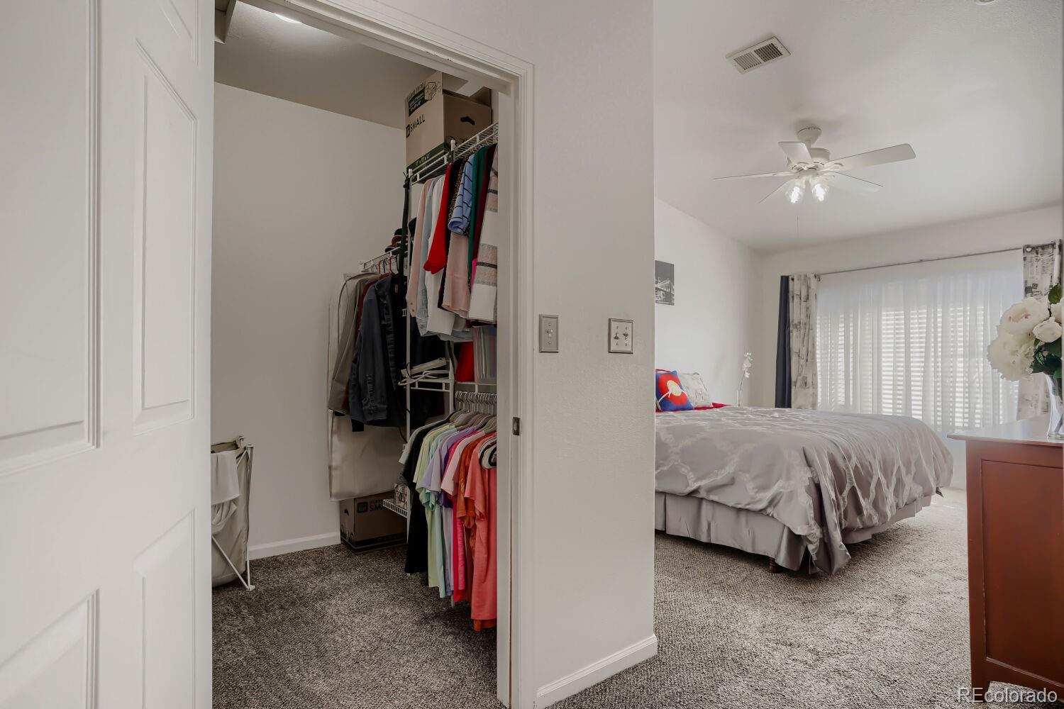 8437 South Thunder Ridge Way, Unit 204 Highlands Ranch, CO 80126 - Photo 13 of 27 a bed room with a bed and a walk in closet