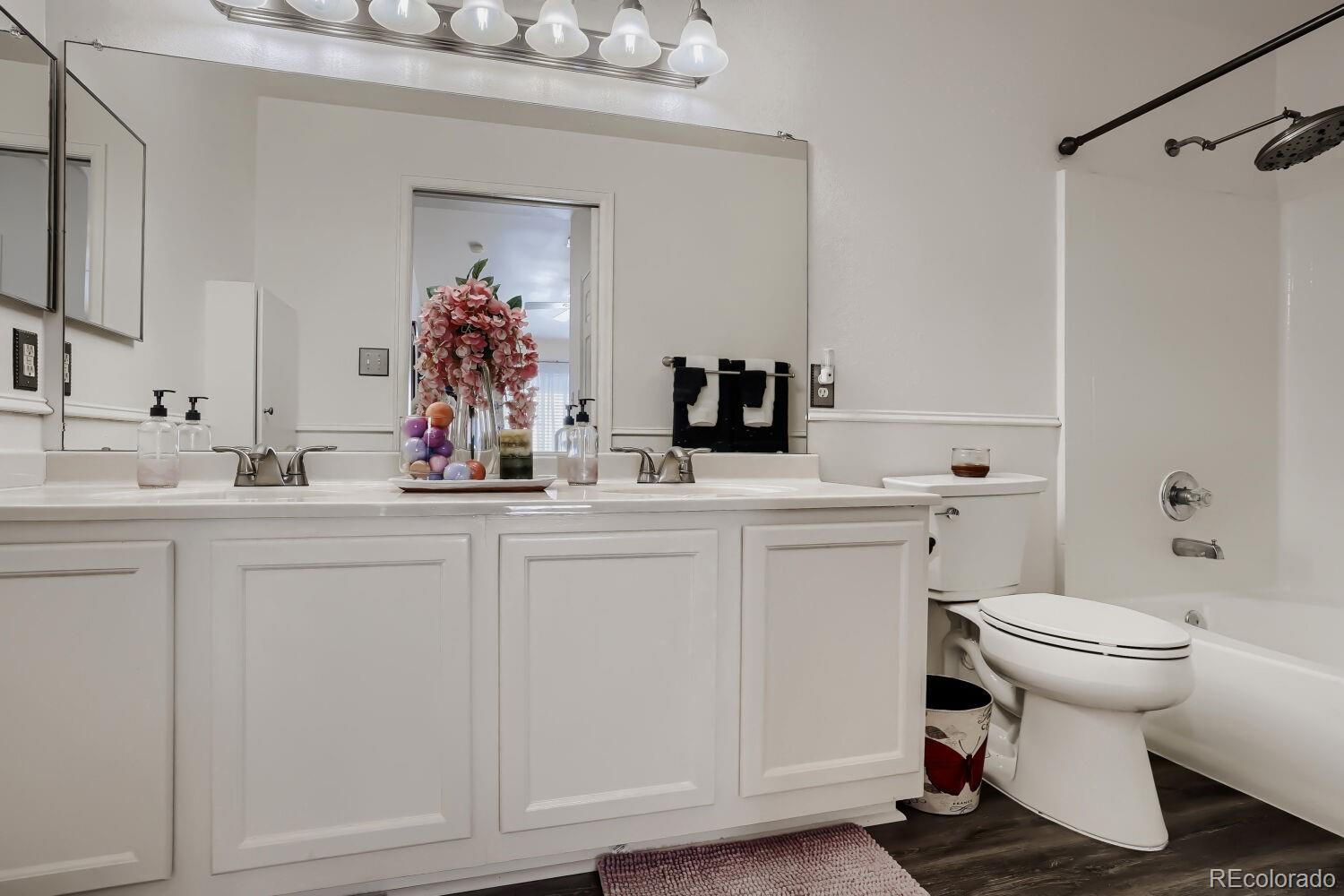 8437 South Thunder Ridge Way, Unit 204 Highlands Ranch, CO 80126 - Photo 14 of 27 a bathroom with a sink toilet and mirror