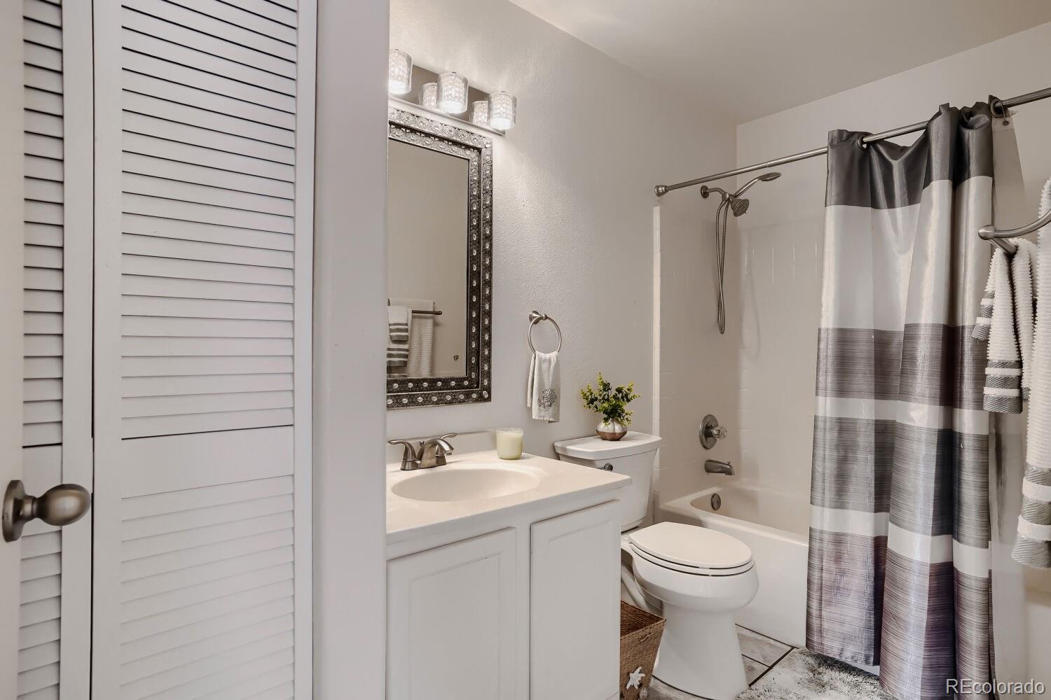 8437 South Thunder Ridge Way, Unit 204 Highlands Ranch, CO 80126 - Photo 18 of 27 a bathroom with a sink toilet and shower