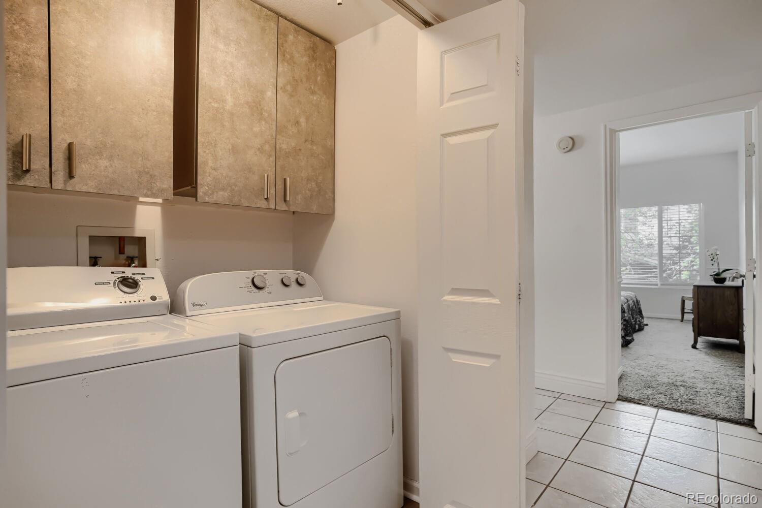 8437 South Thunder Ridge Way, Unit 204 Highlands Ranch, CO 80126 - Photo 19 of 27 a view of storage and utility room with washer and dryer