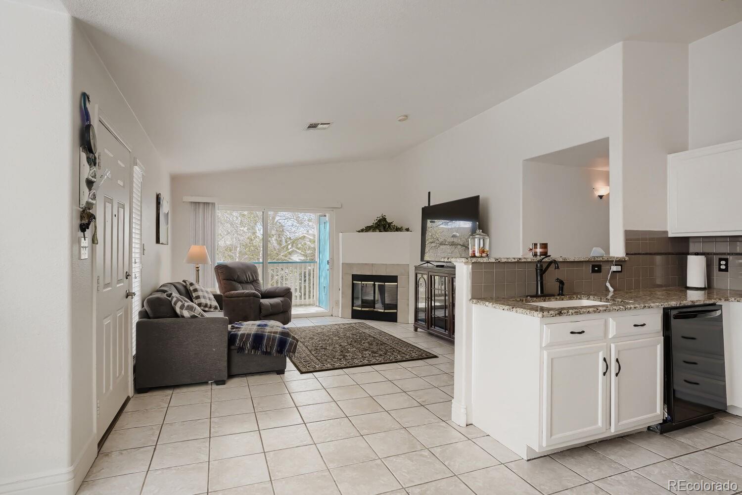 8437 South Thunder Ridge Way, Unit 204 Highlands Ranch, CO 80126 - Photo 5 of 27 a kitchen with a cabinets and fireplace