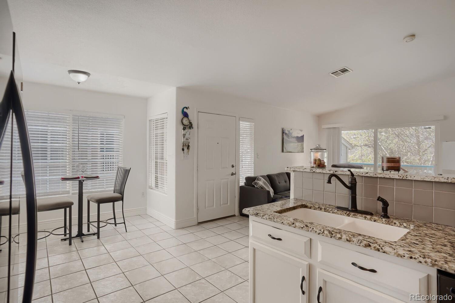 8437 South Thunder Ridge Way, Unit 204 Highlands Ranch, CO 80126 - Photo 9 of 27 a view of kitchen with furniture and refrigerator