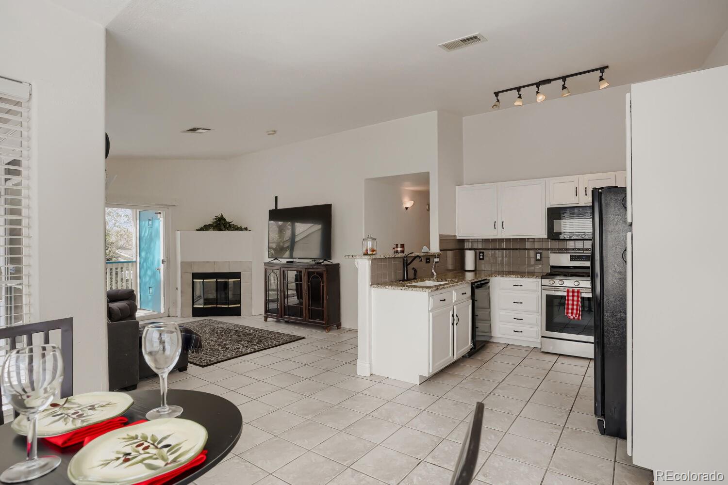 8437 South Thunder Ridge Way, Unit 204 Highlands Ranch, CO 80126 - Photo 10 of 27 a open kitchen with sink cabinets and stainless steel appliances