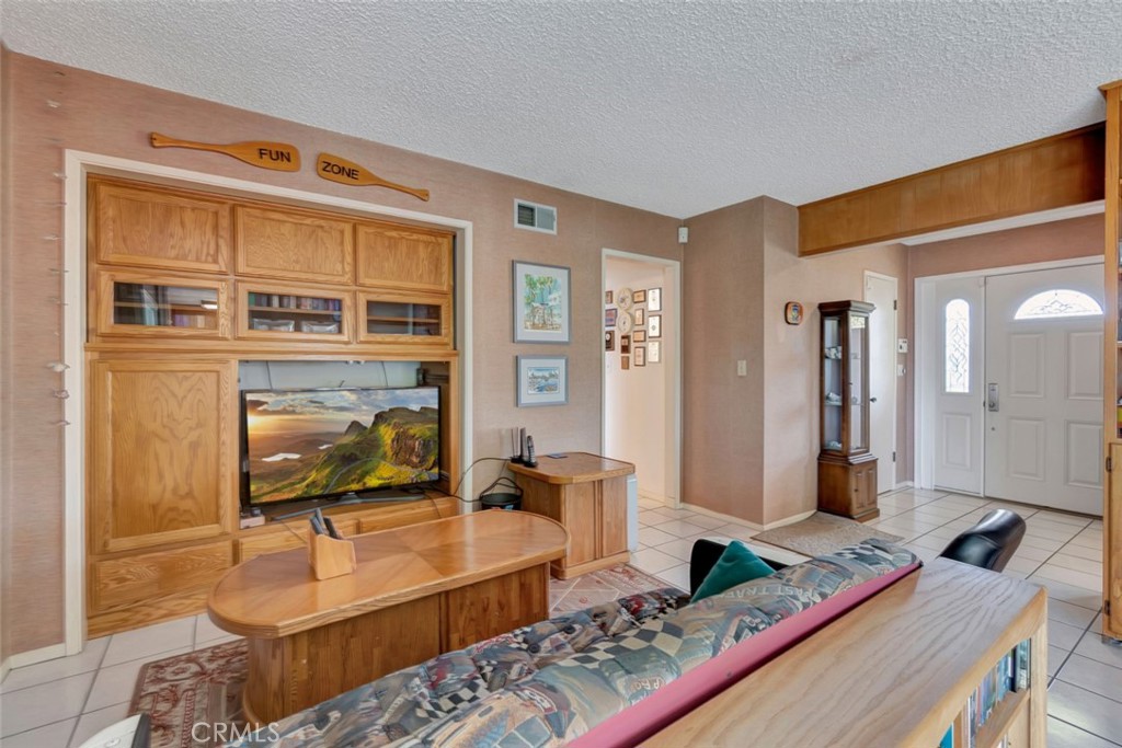1602 Minorca Drive Costa Mesa, CA 92626 - Photo 12 of 33 a living room with furniture and a flat screen tv
