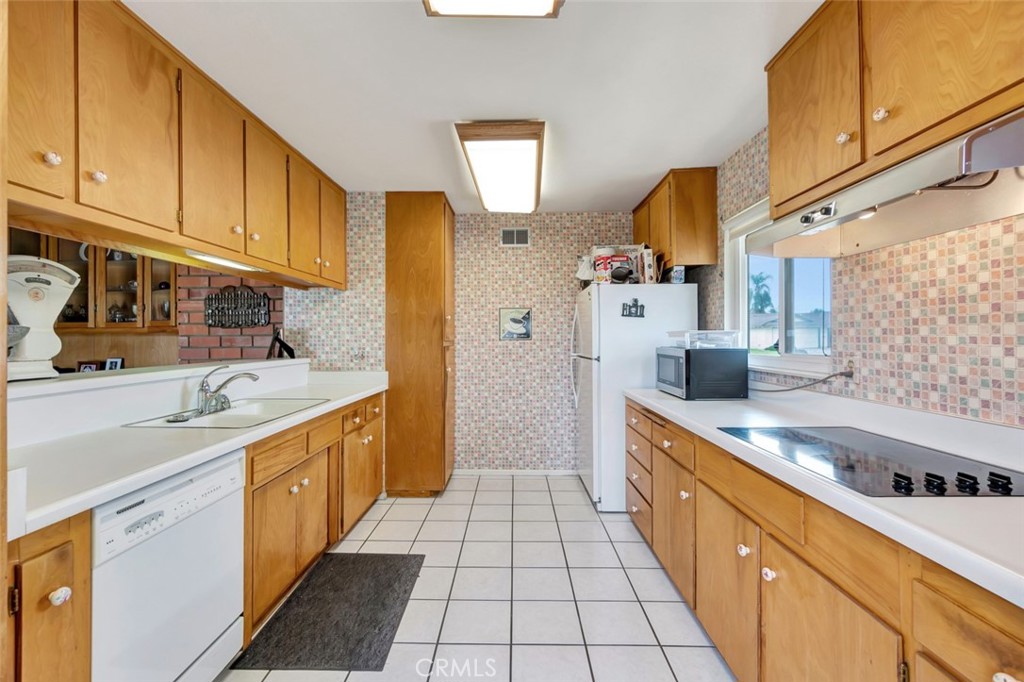 1602 Minorca Drive Costa Mesa, CA 92626 - Photo 18 of 33 a kitchen with stainless steel appliances granite countertop a sink and cabinets