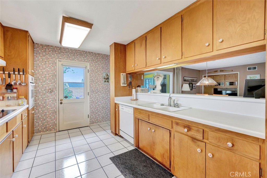 1602 Minorca Drive Costa Mesa, CA 92626 - Photo 19 of 33 a kitchen with a sink and cabinets