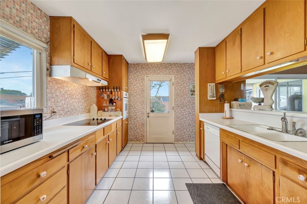 1602 Minorca Drive Costa Mesa, CA 92626 - Photo 20 of 33 a large kitchen with stainless steel appliances granite countertop a sink and cabinets