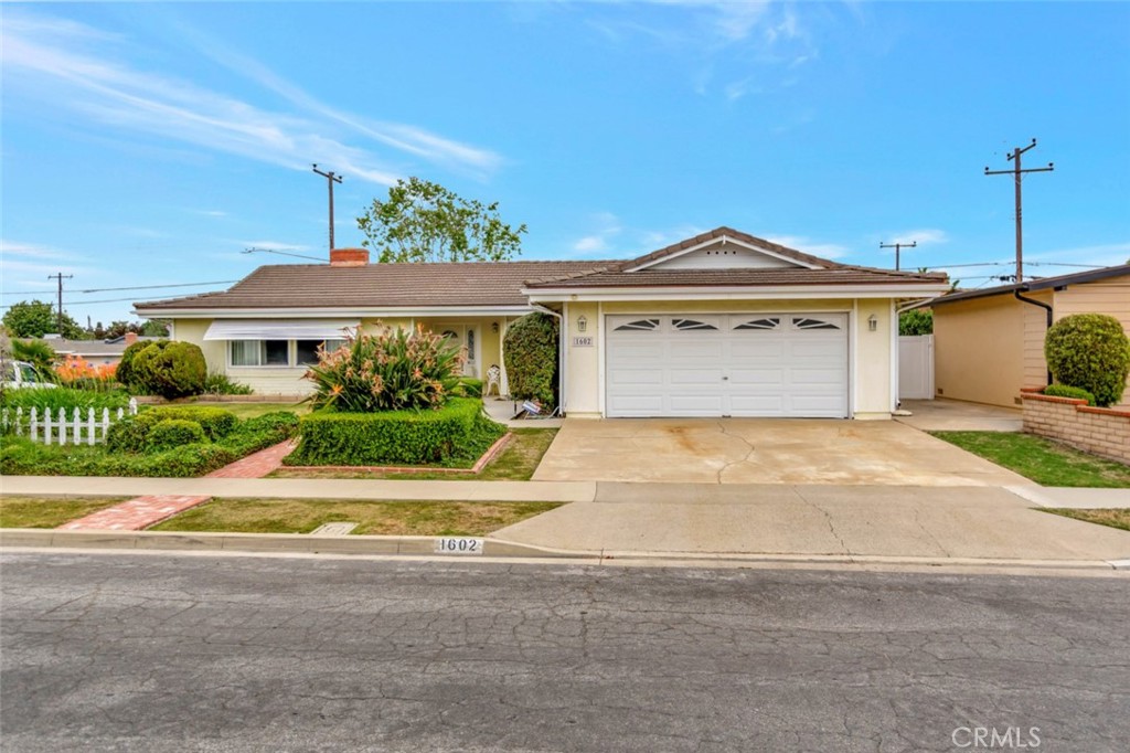 1602 Minorca Drive Costa Mesa, CA 92626 - Photo 2 of 33 a front view of a house with a yard and garage